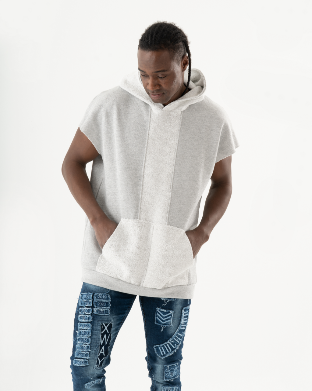 A black man wearing a BACHELOR HOODIE| WHITE with a pouch pocket.