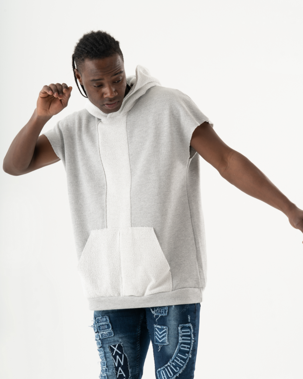 A man wearing regular cut jeans and a BACHELOR HOODIE | WHITE with a big pouch pocket.