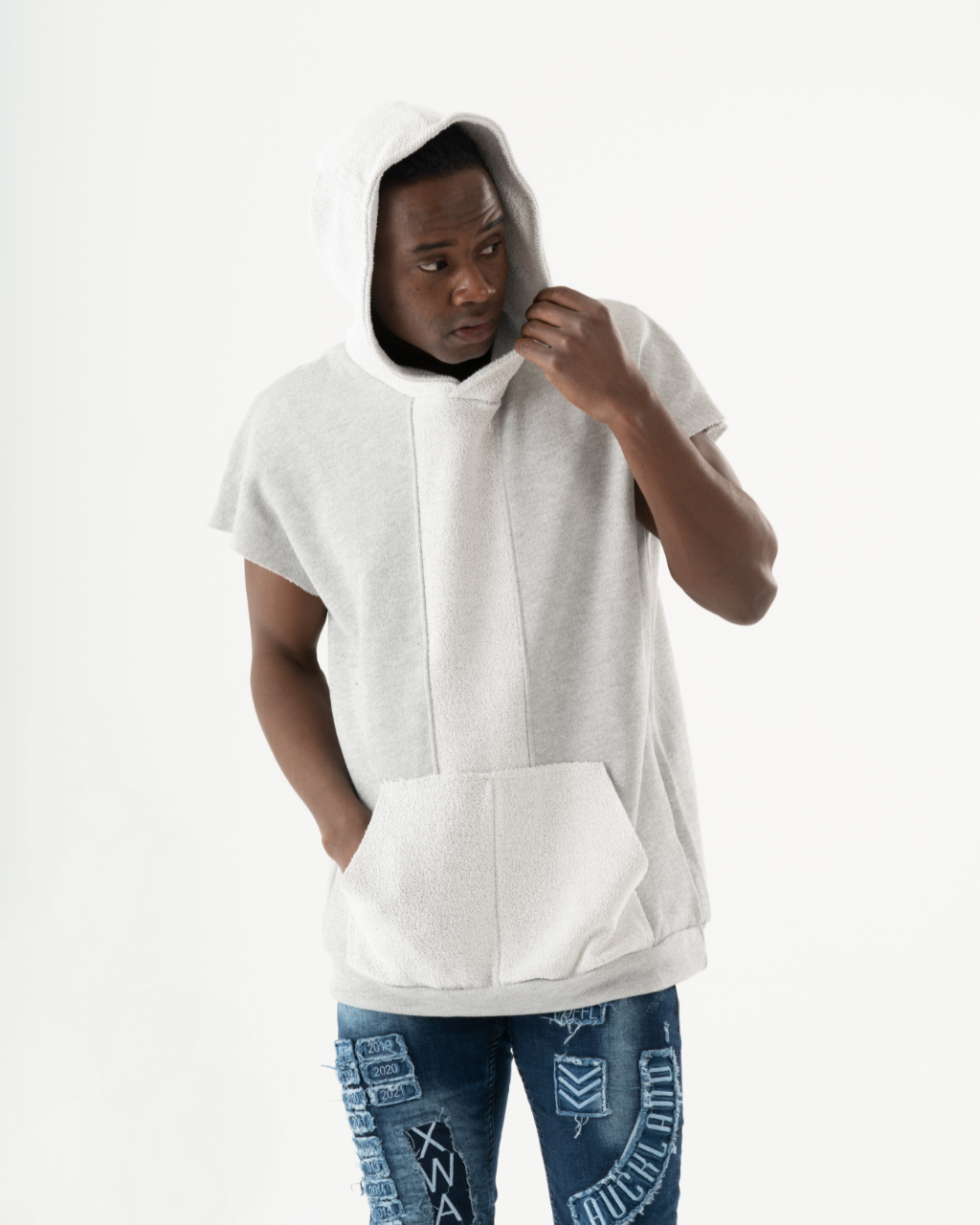 A man wearing a BACHELOR HOODIE | WHITE with a pouch pocket.