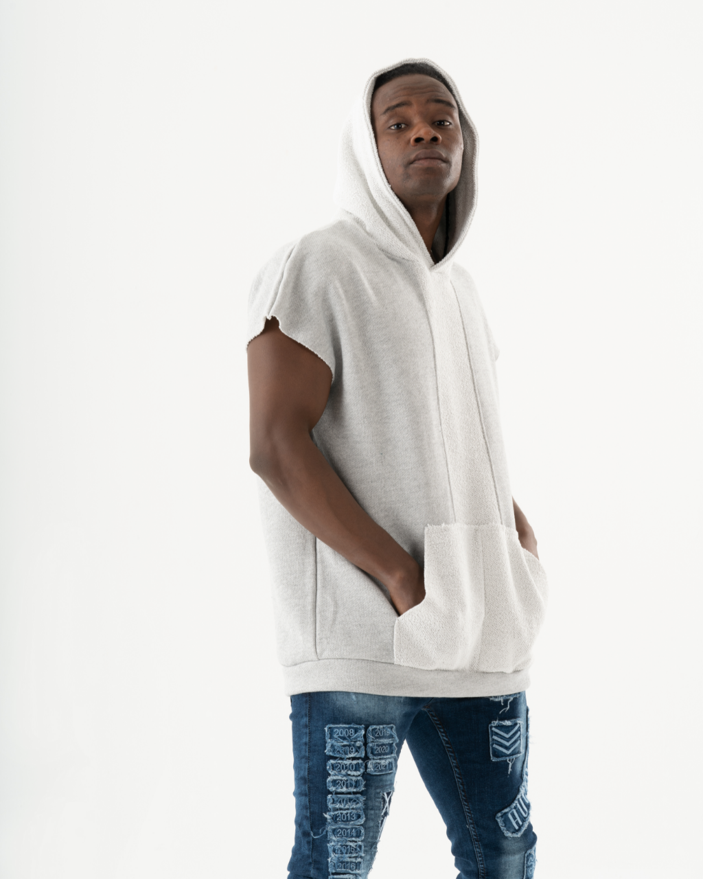 A man in a BACHELOR HOODIE | WHITE with a big pouch pocket.