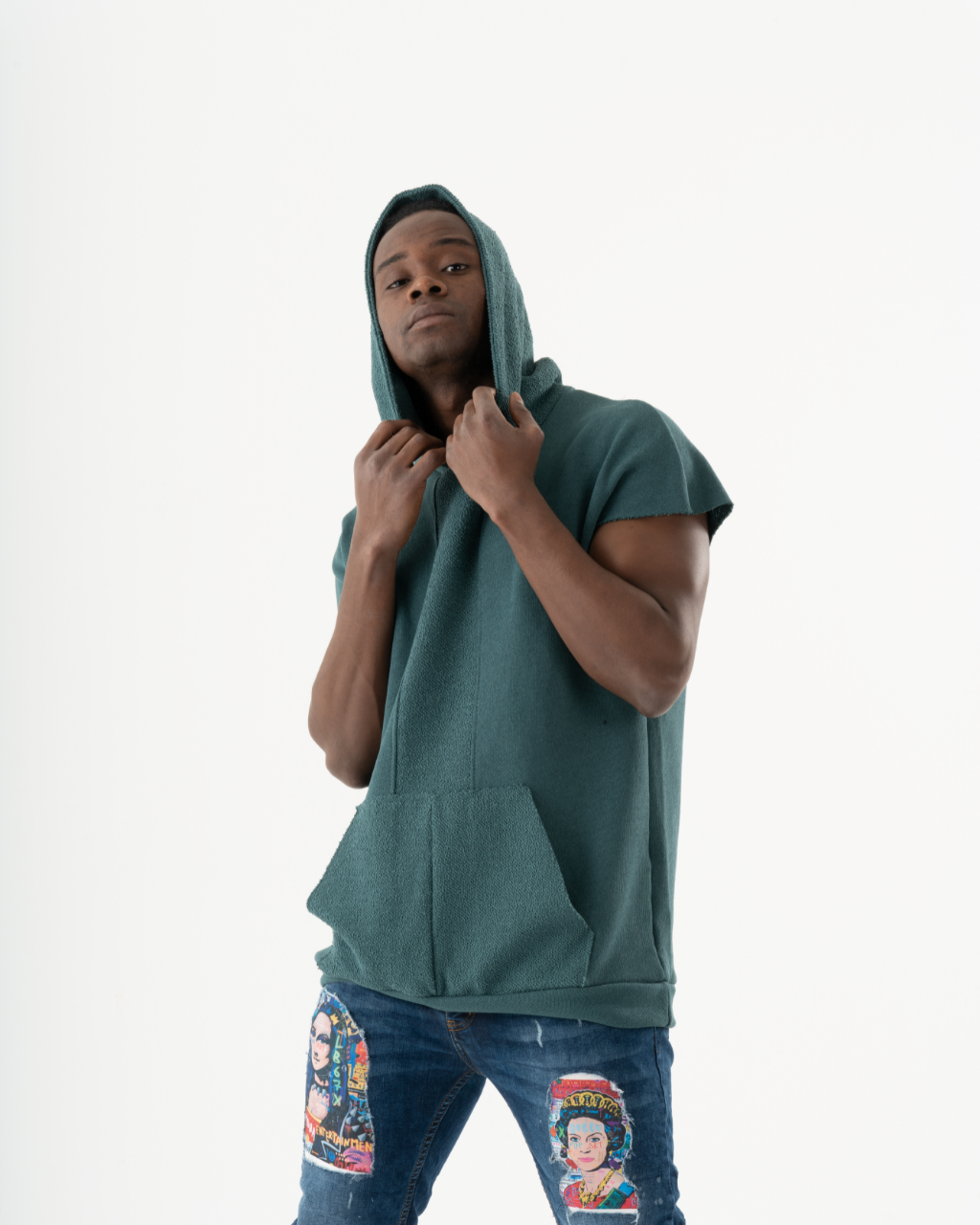 A man wearing a BACHELOR HOODIE | GREEN and jeans.