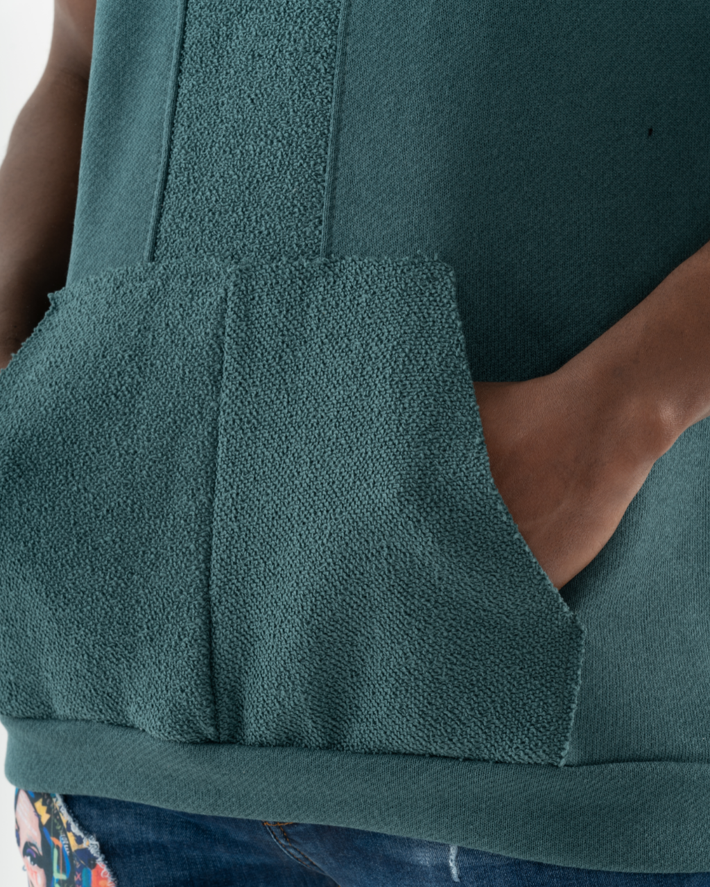 A woman wearing a BACHELOR HOODIE | GREEN with a pouch pocket.