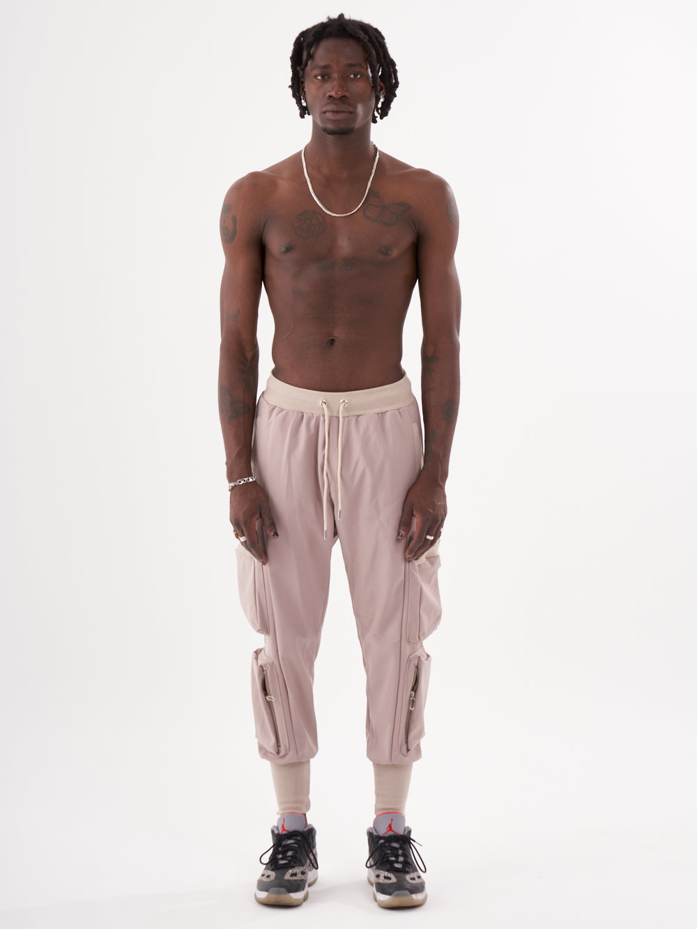 A man wearing OUTLIER | MAUVE cargo jogger pants.