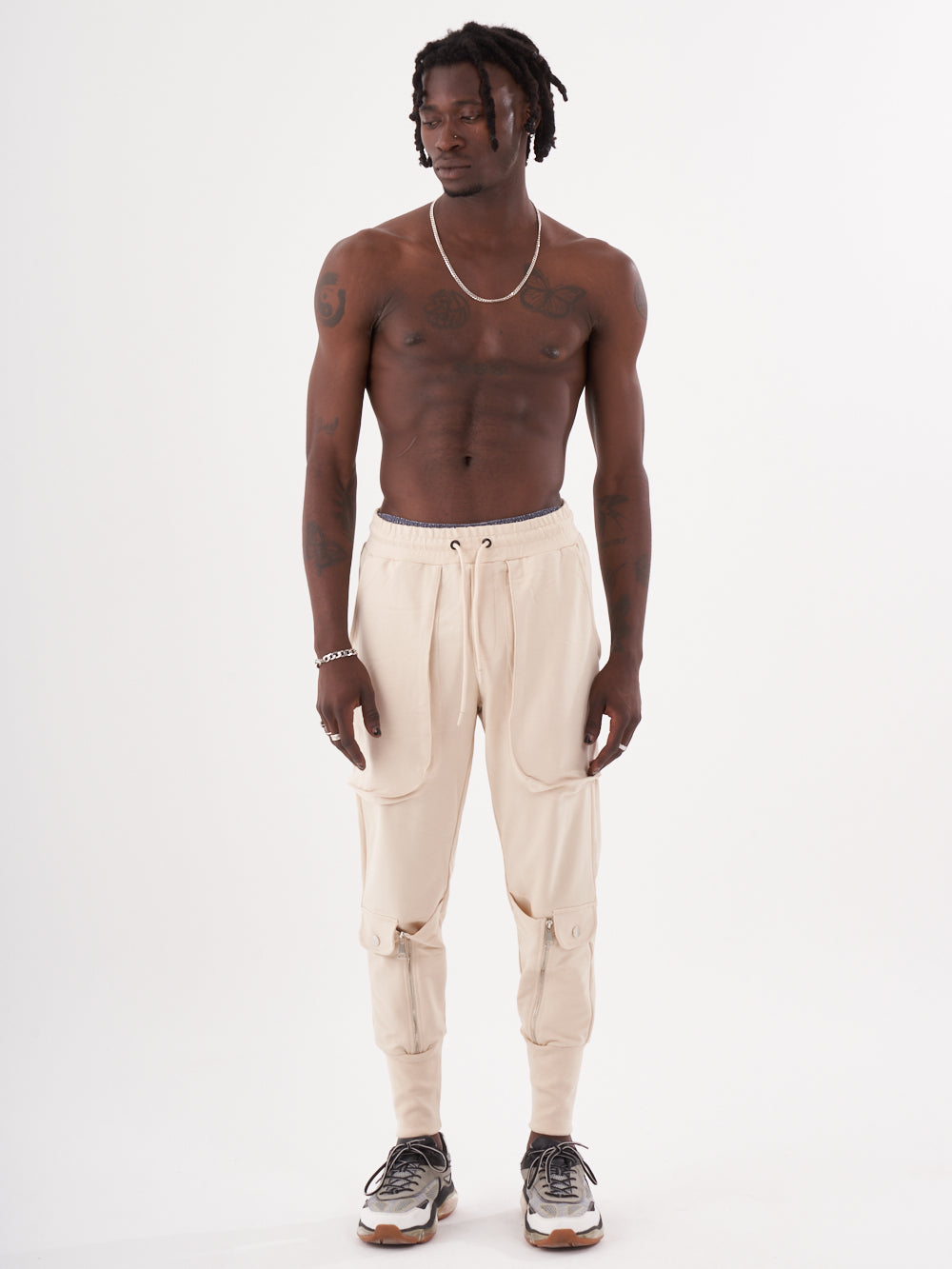 The model is wearing beige jogger pants.