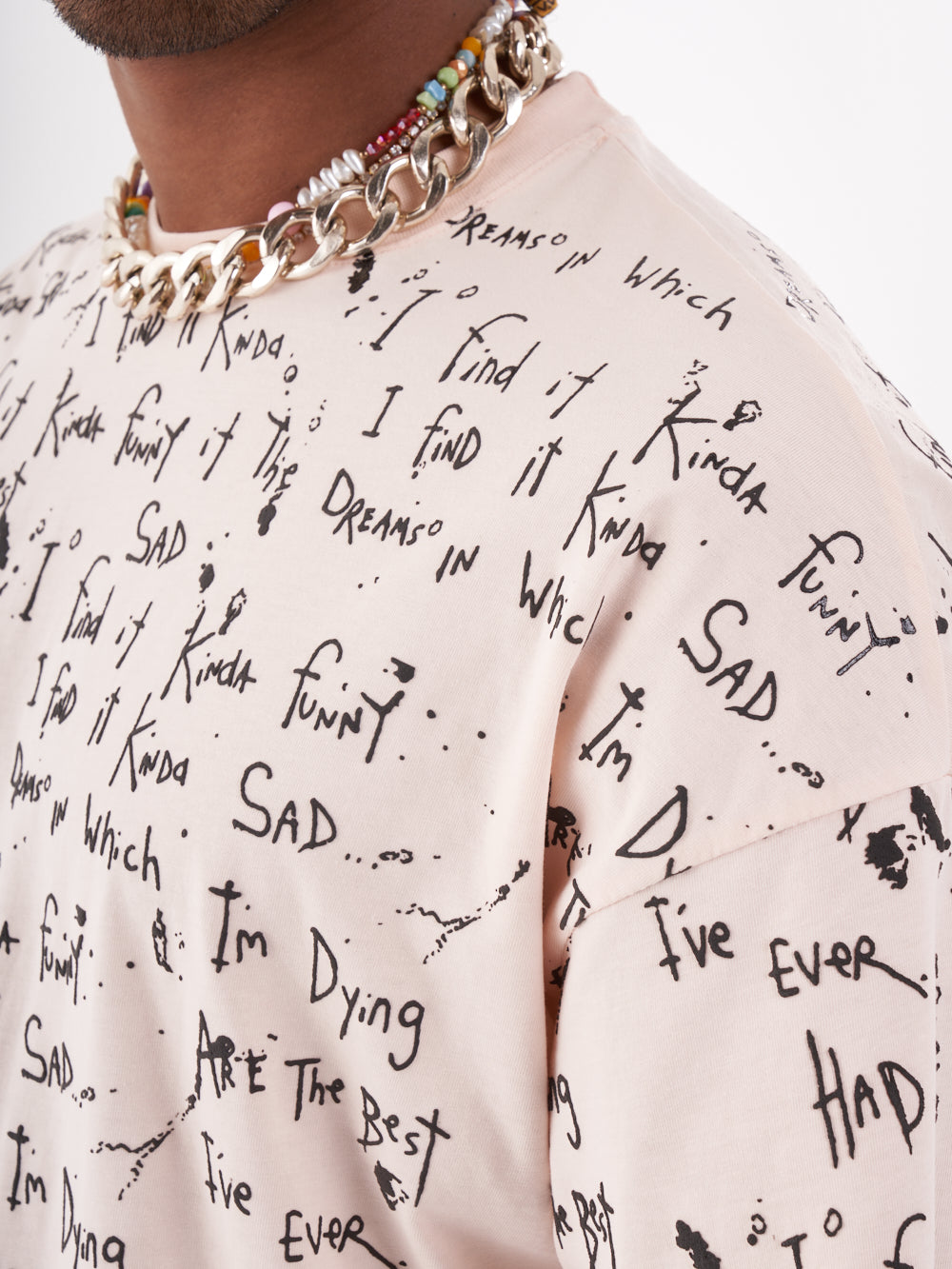 A man wearing a THINKER T-SHIRT with writing on it.