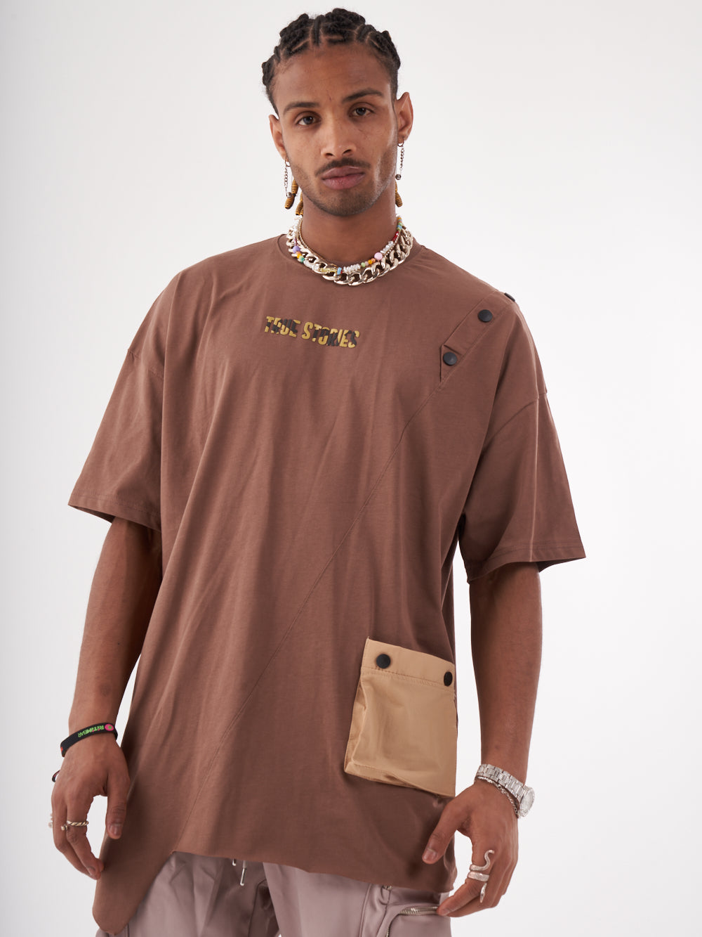 The man is wearing a brown BEATNIK T-SHIRT with a pocket.