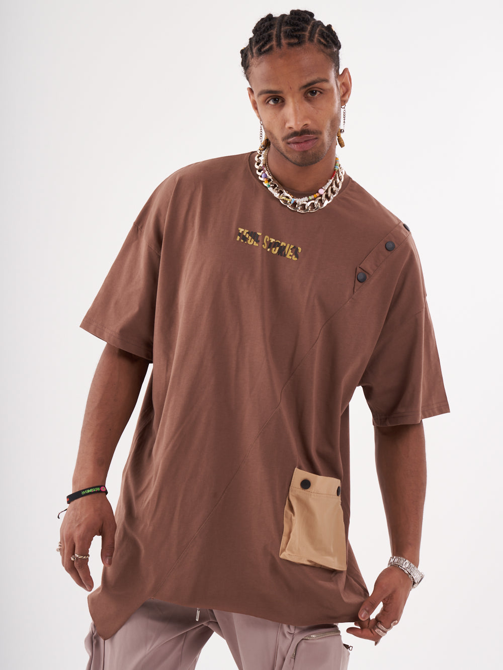 A man wearing a BEATNIK T-SHIRT and khaki pants.