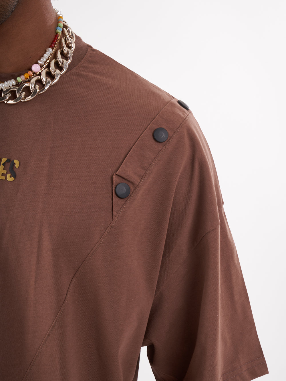 A man wearing a BEATNIK T-SHIRT with a chain necklace.