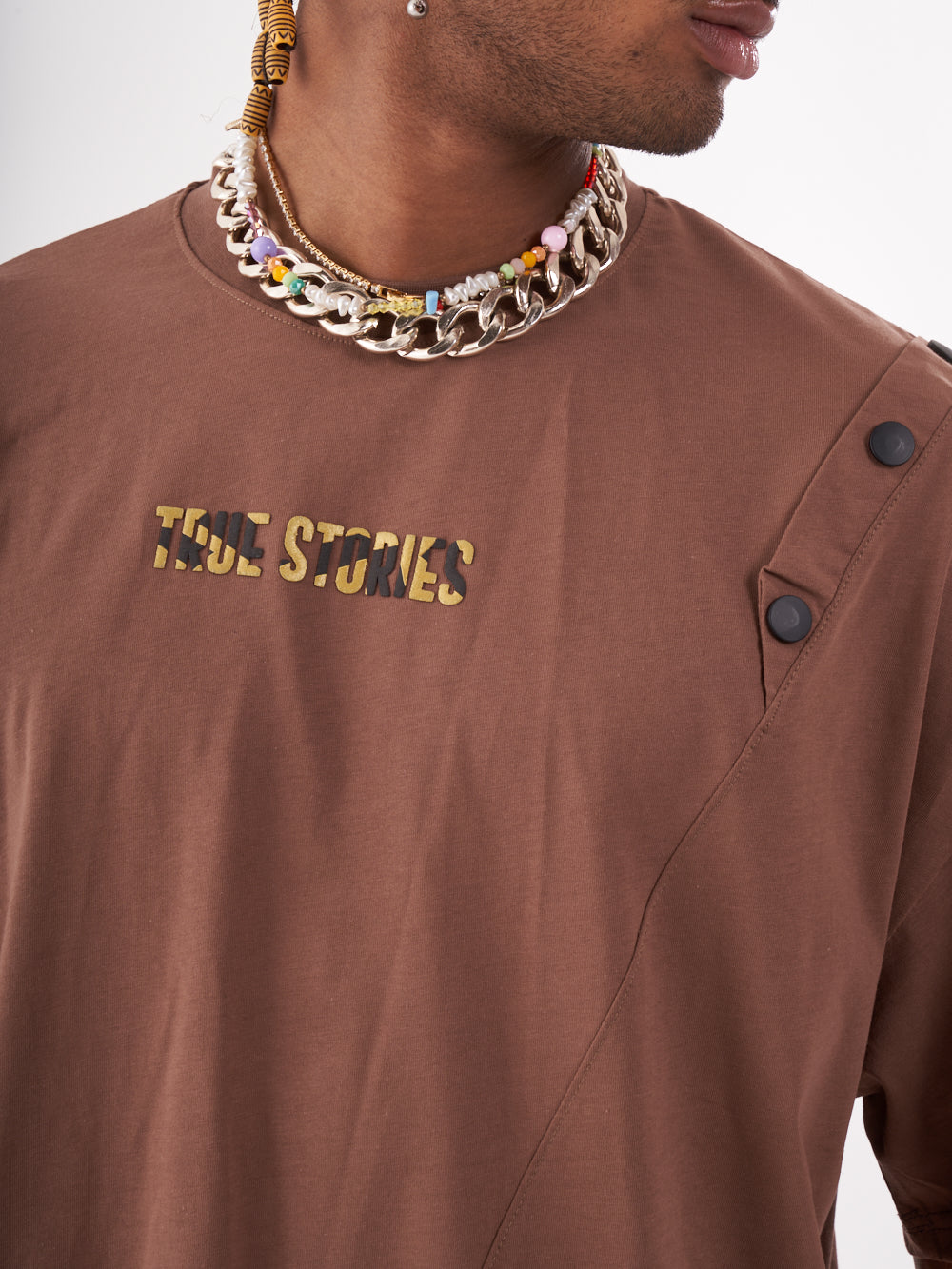 A man wearing a brown long sleeve Beatnik t-shirt.