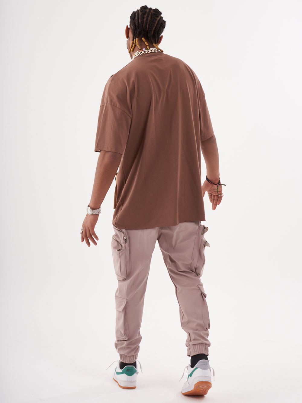 The back of a man wearing a BEATNIK T-SHIRT and cargo pants.