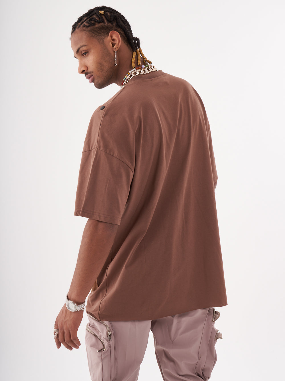 The back of a man wearing a Beatnik t-shirt and pants.