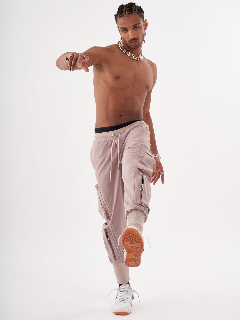 A OUTLIER | MAUVE-shirtless man posing for a photo.