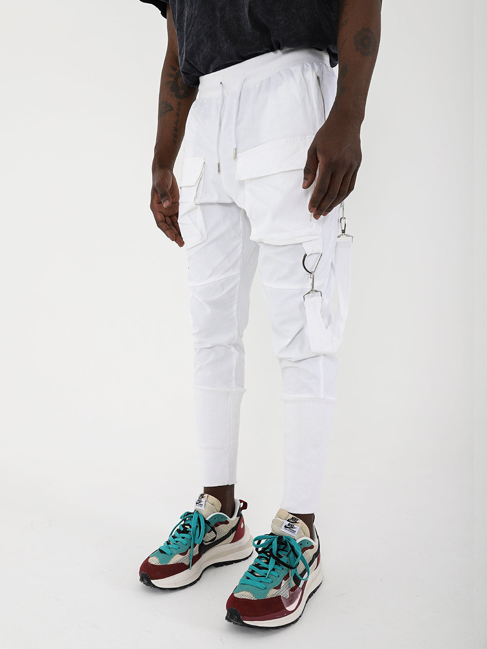 A slim fit Brooklyn jogger sporting white cargo pants and sneakers with an adjustable drawstring waist.