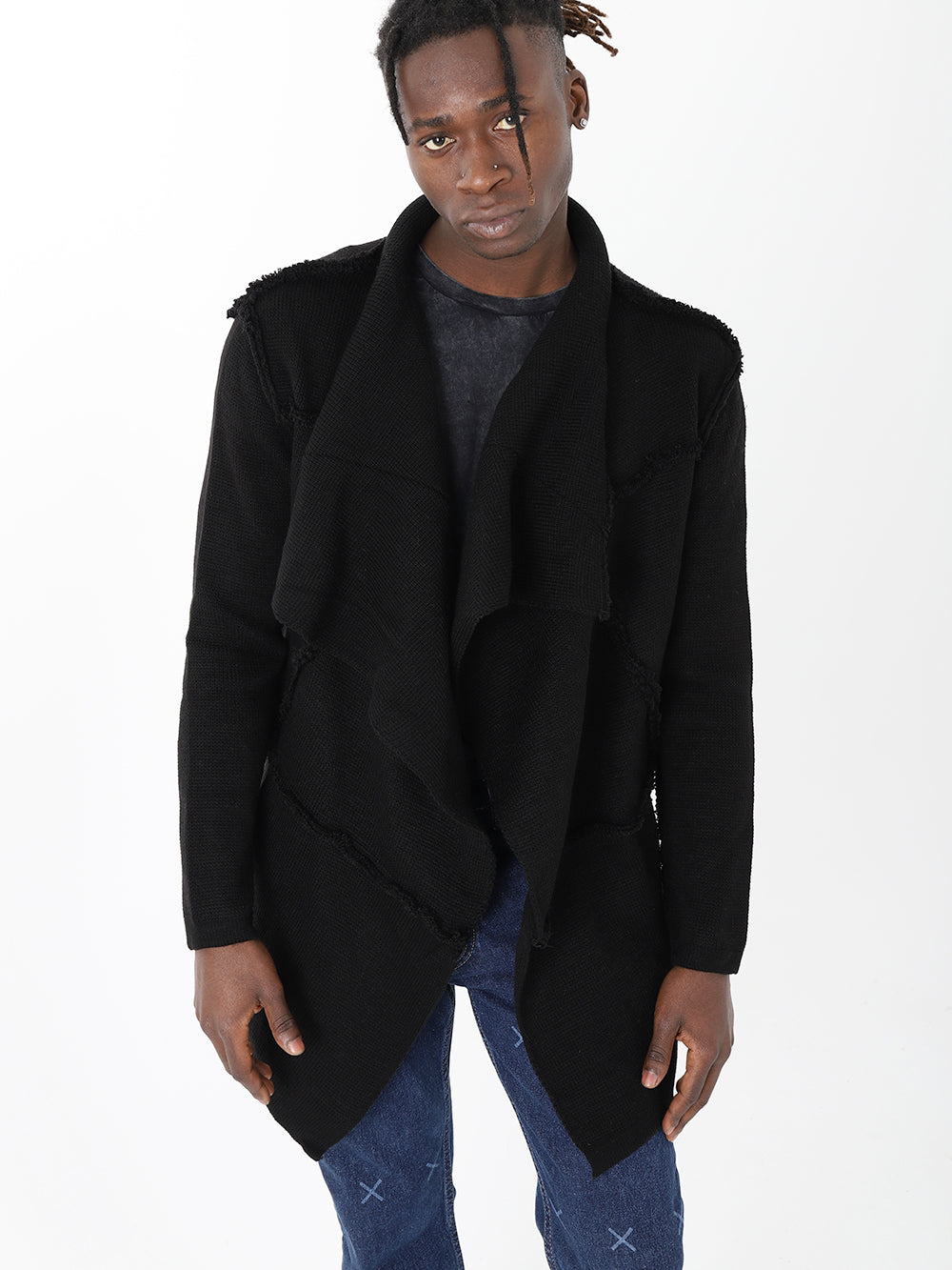 A man in skinny fit jeans and a HOODED DISTRESSED CARDIGAN // BLACK jacket.