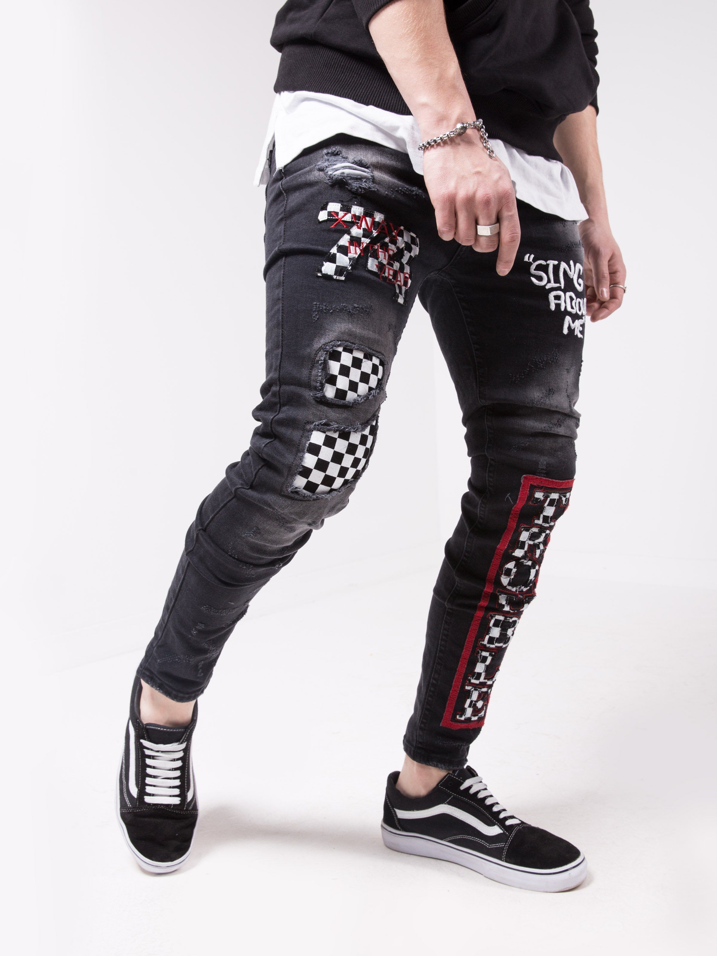 A man wearing a pair of FORMULA TROPHY jeans and sneakers.