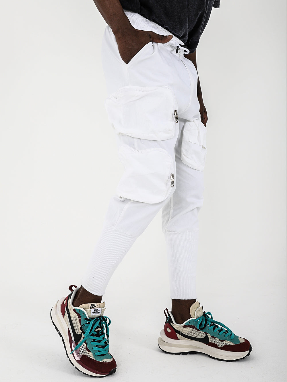 A man wearing white STERLING JOGGERS pants and sneakers.