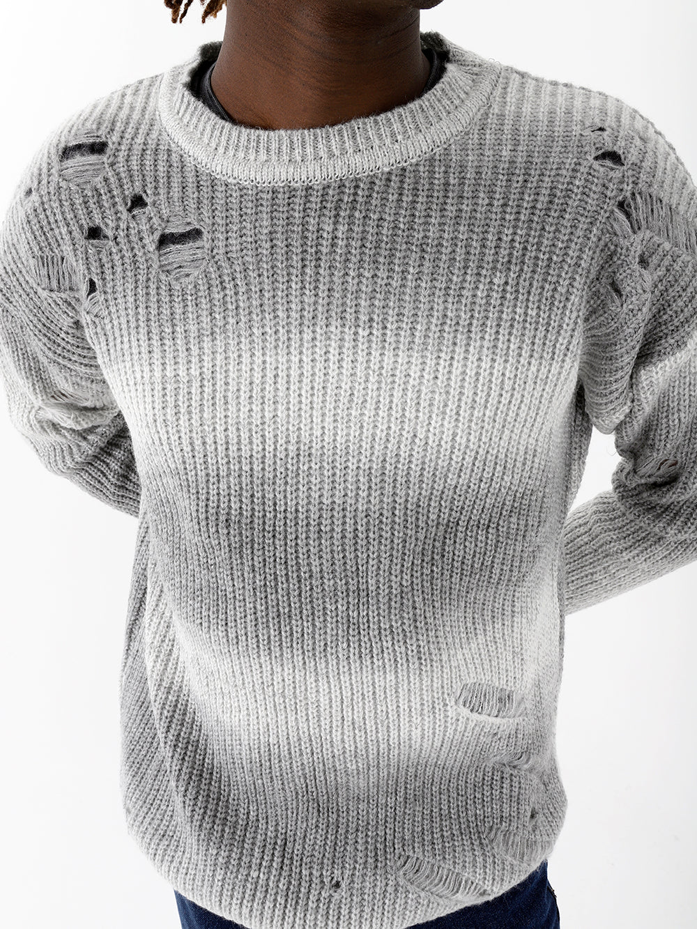 A black woman wearing a DISTRESSED GENTLEMAN SWEATER | WHITE-GRAY.
