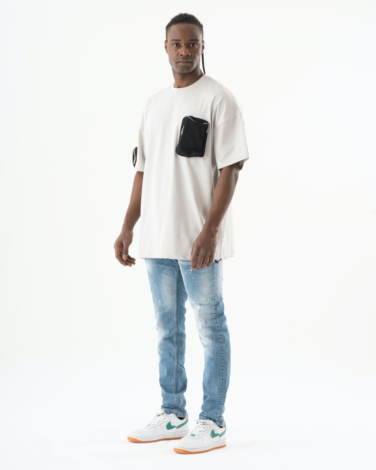 A man wearing Levi's jeans and a t-shirt standing in front of a white background.