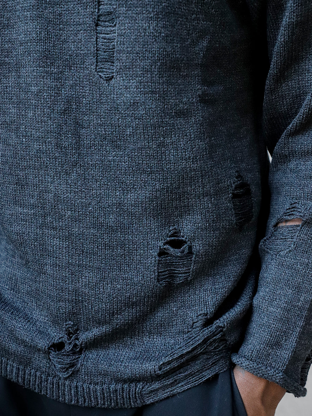 A man wearing a Distressed Gentleman Sweater | Charcoal.