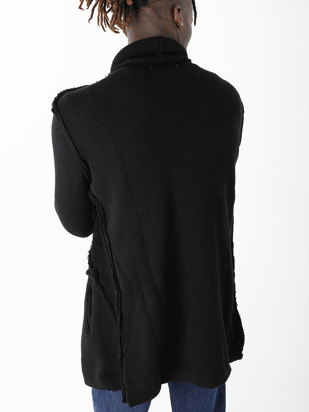 The back of a man wearing HOODED DISTRESSED CARDIGAN // BLACK skinny fit jeans and a black sweater.