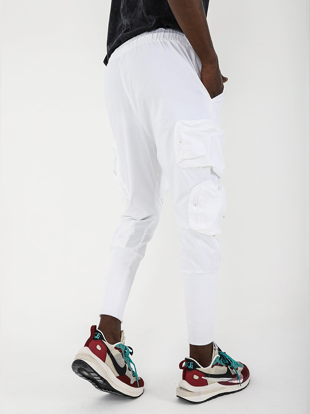 A man wearing STERLING joggers and sneakers.