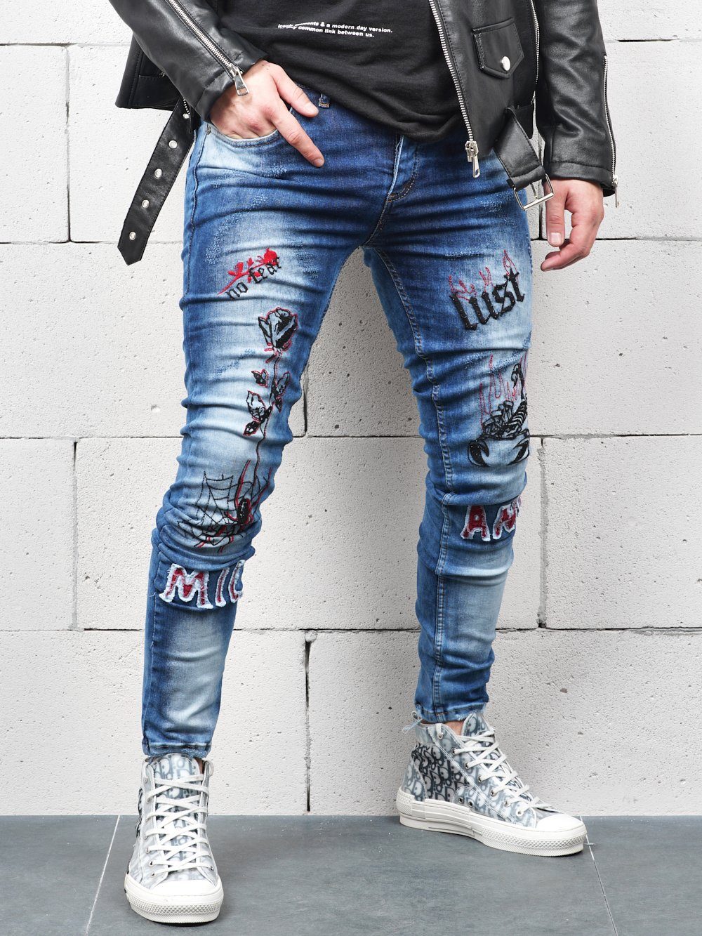 Lower body shot of a man wearing ROSE TATTOO skinny jeans