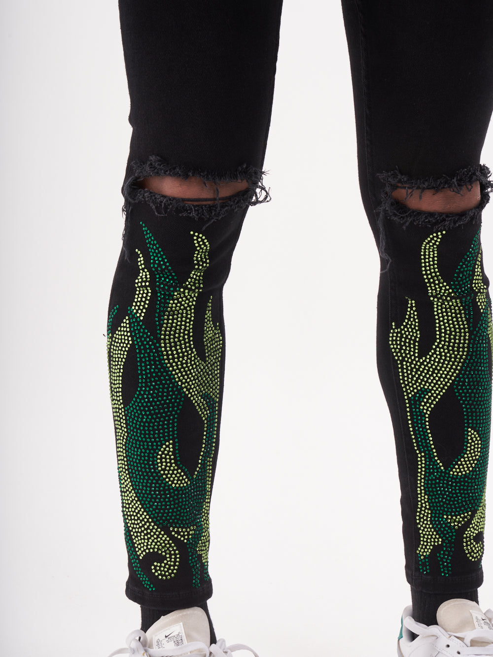 A pair of black and HELLFIRE | GREEN beaded leggings.