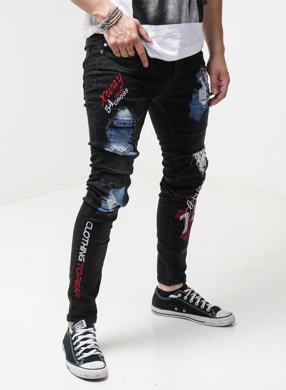 A man in INSIDER ripped jeans and a t-shirt.