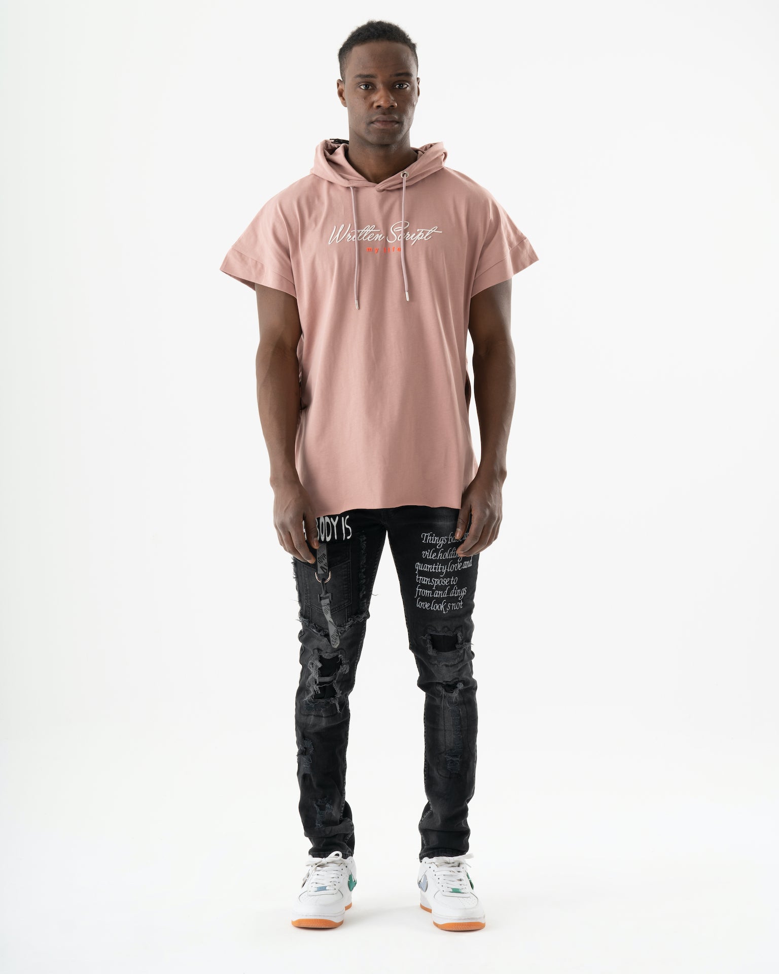 A man wearing a ONE SOUL hoodie and black jeans.