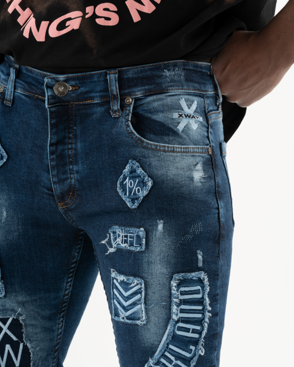 A man in an INJUN | BLUE skinny fit t-shirt and ripped jeans.