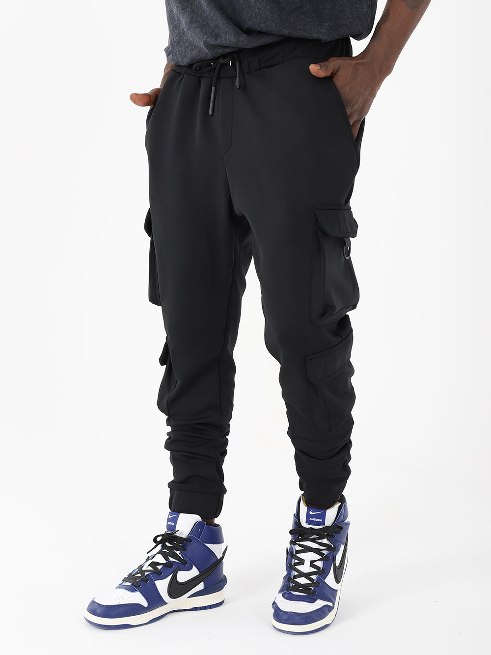 A man wearing VENTURA JOGGERS ankle cuffs and sneakers.