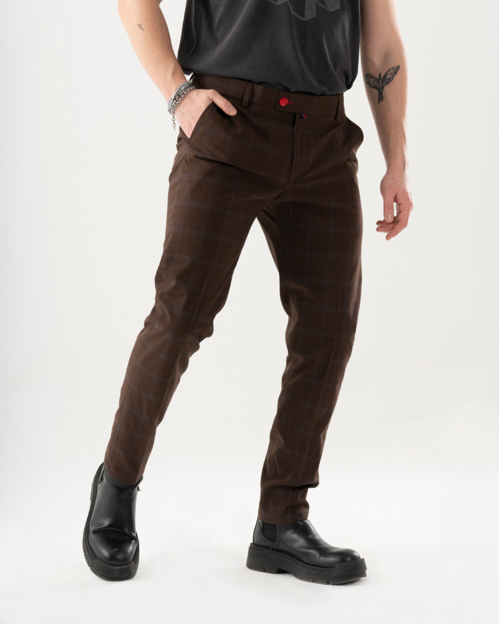 A man wearing High-Castle pants and a black t-shirt.
