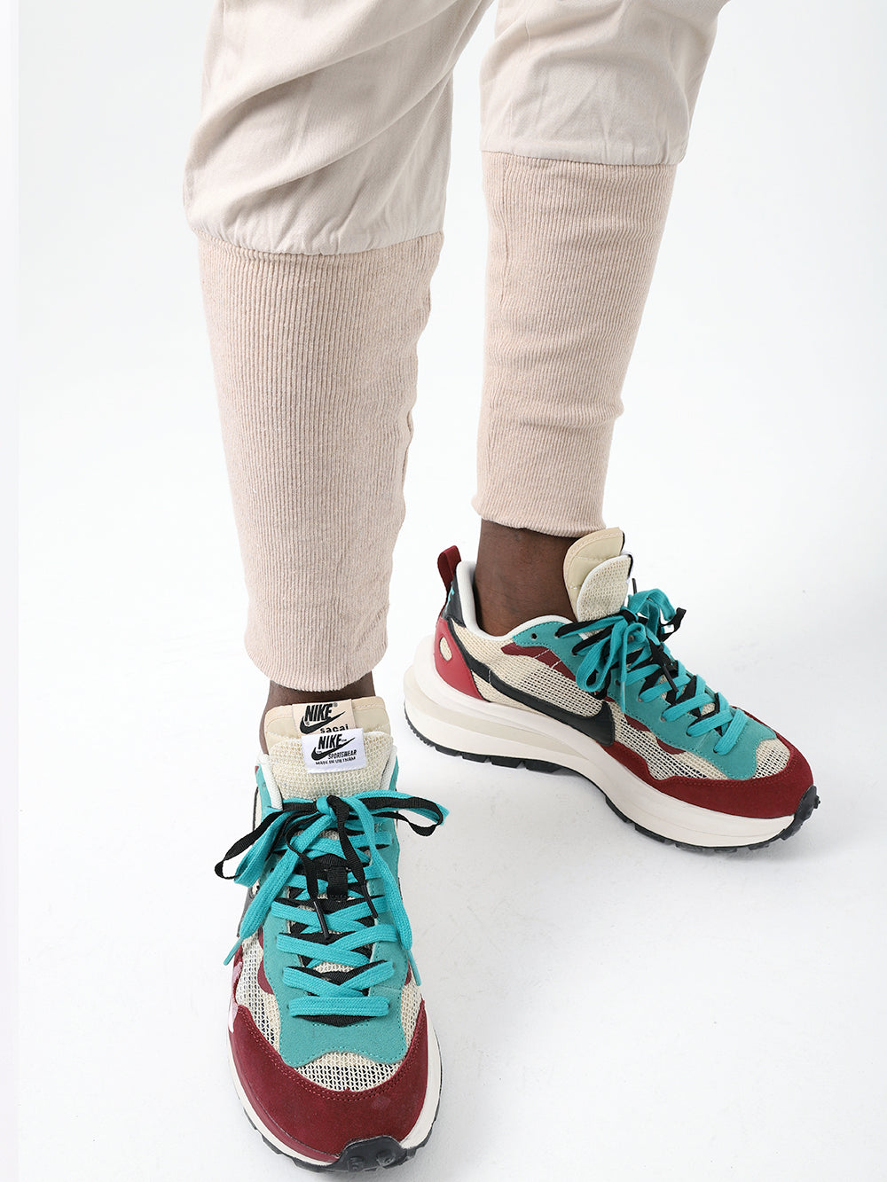 The legs of a person wearing a pair of ALTIS JOGGERS in fashion item.