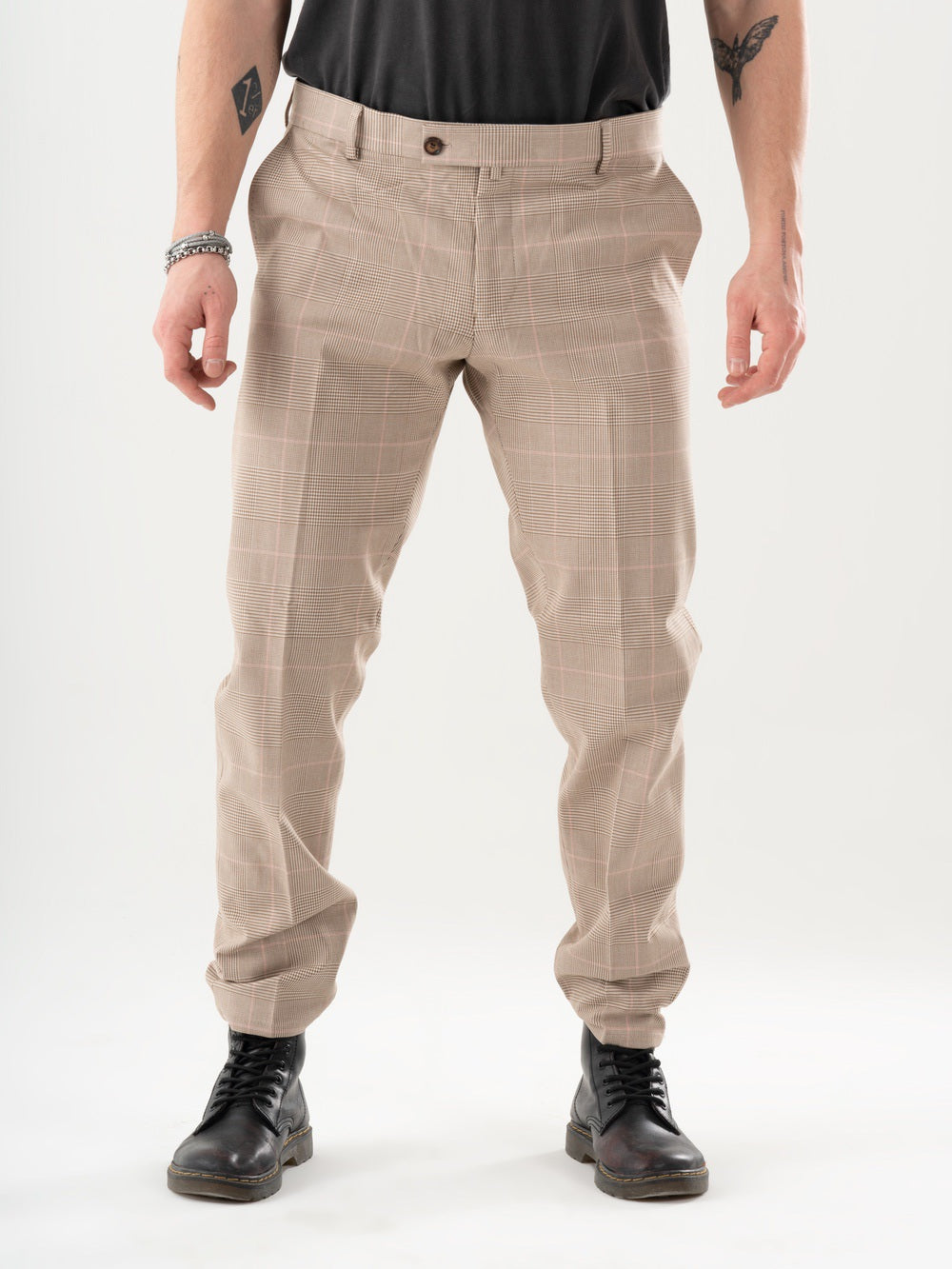 A man wearing MOONSHOT PANTS in a beige color.