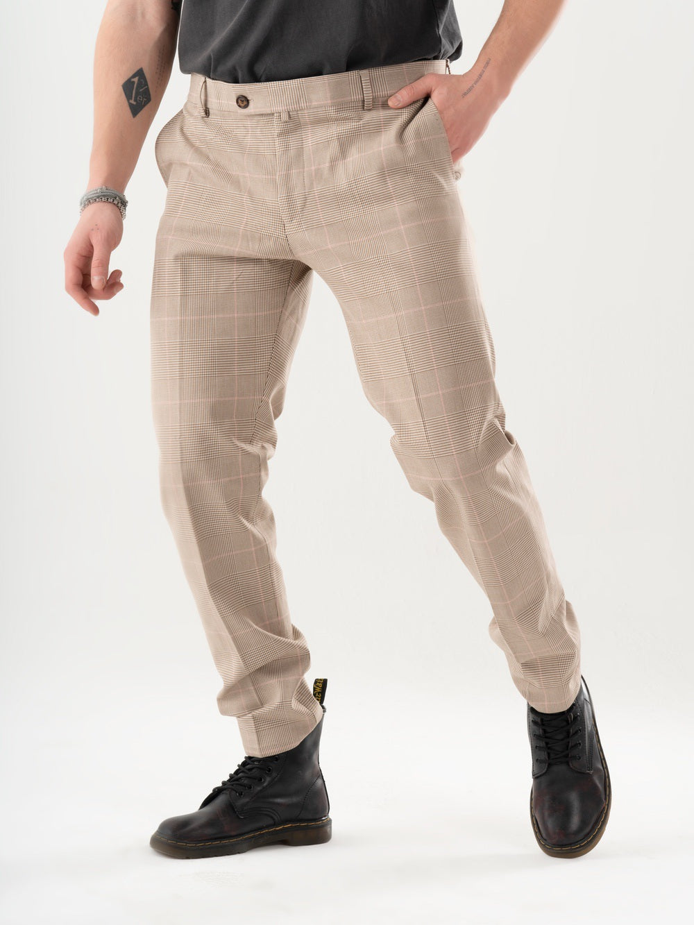 A man is standing in a studio wearing Moonshot pants.
