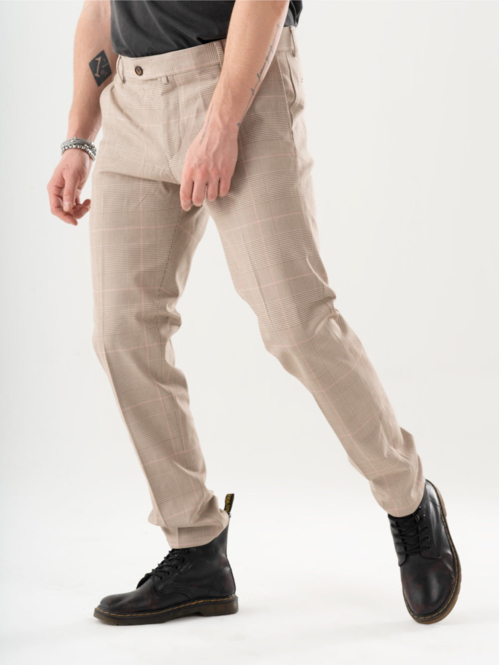 A man is standing in a studio wearing MOONSHOT PANTS.