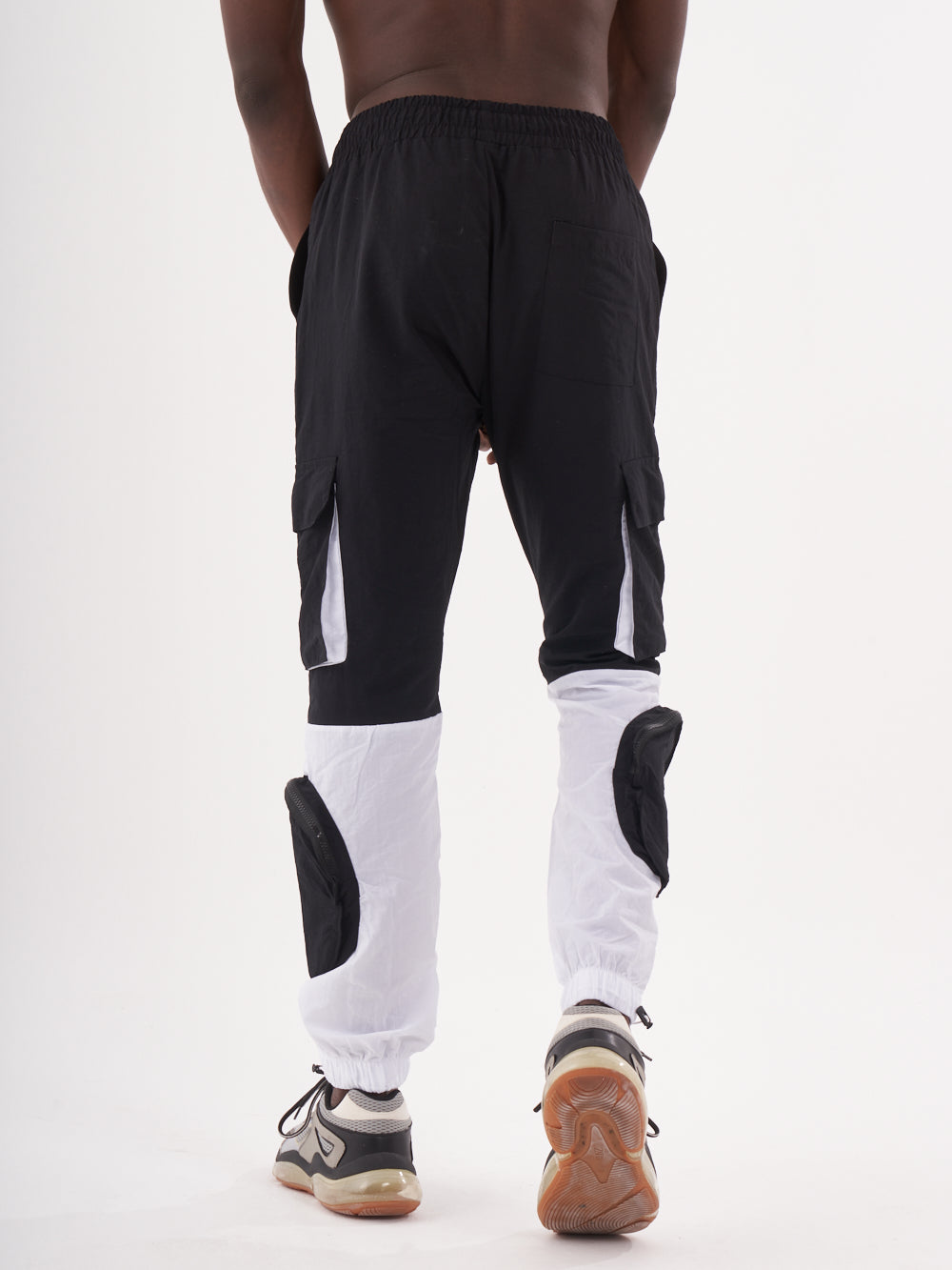 The back view of a man wearing RENEGADE | BLACK cargo pants.