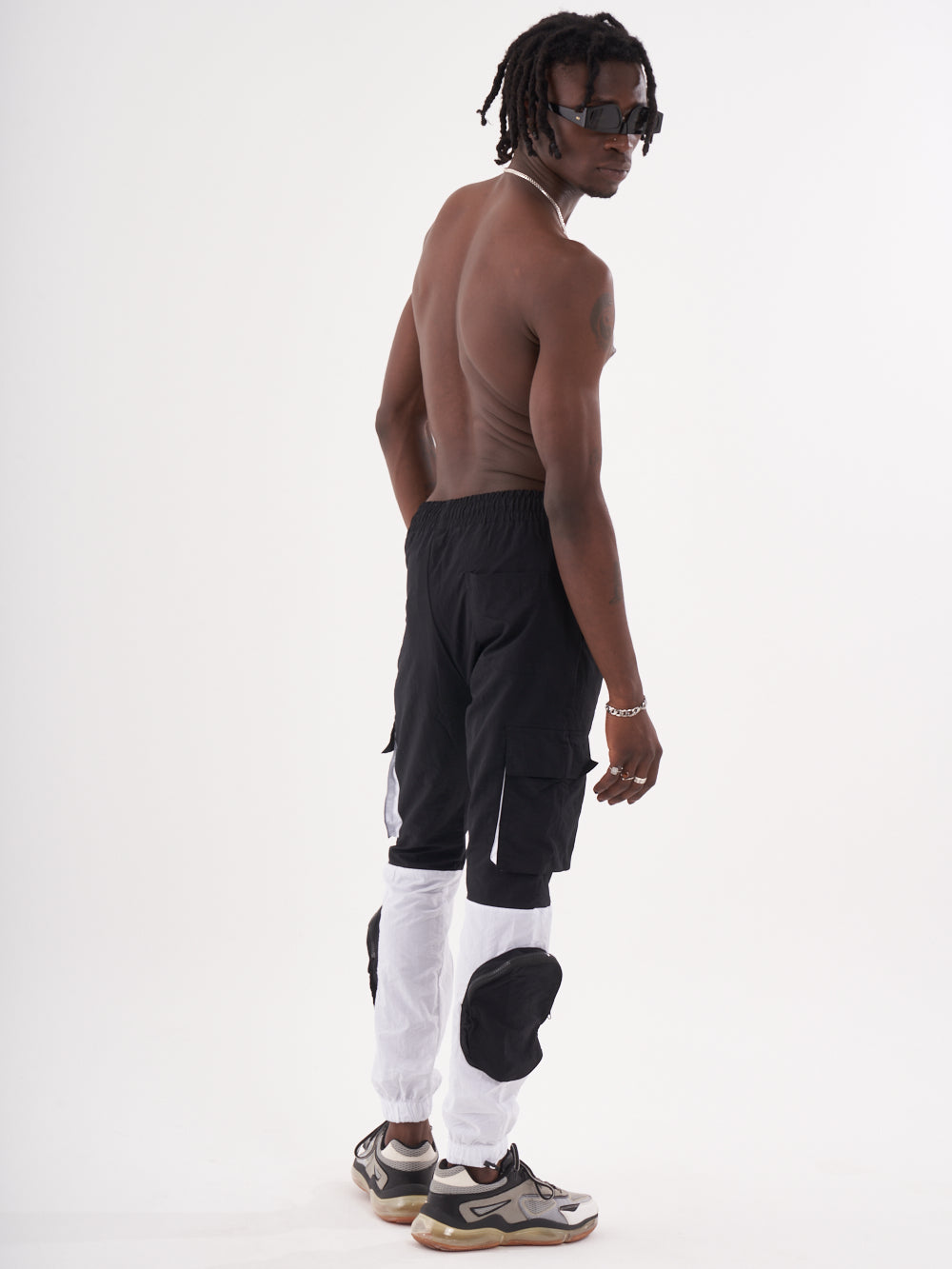 The back of a man wearing RENEGADE | BLACK cargo pants.