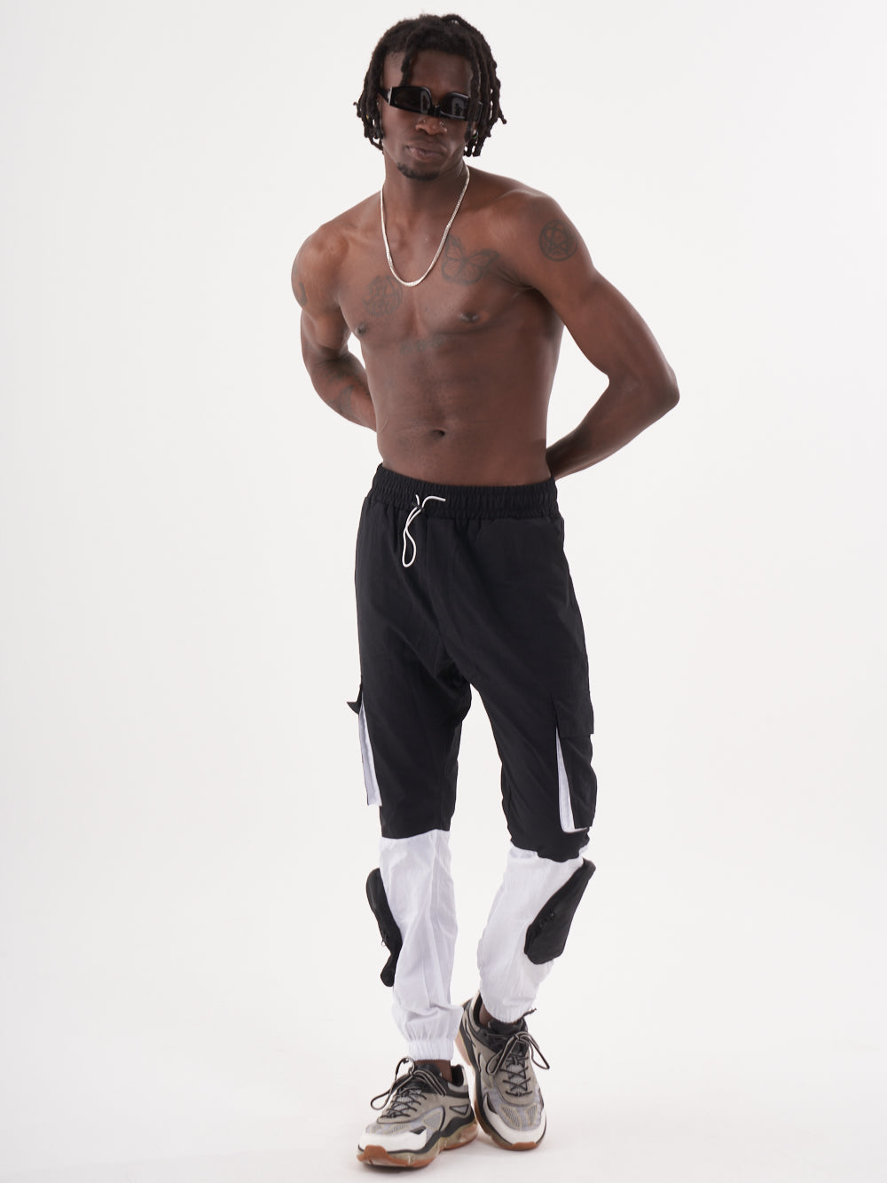 A man in RENEGADE | BLACK joggers posing for a photo with elastic ankles.