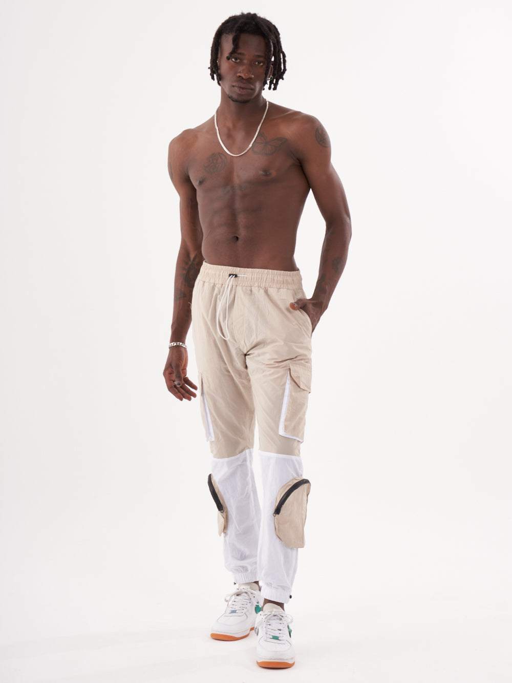 A man wearing a RENEGADE | BEIGE cargo jogger pants.