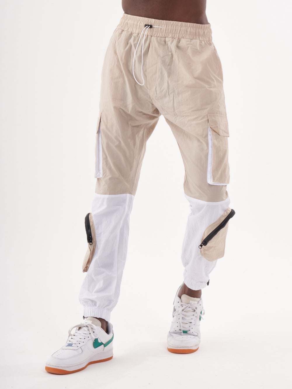 A man wearing RENEGADE | BEIGE cargo pants.