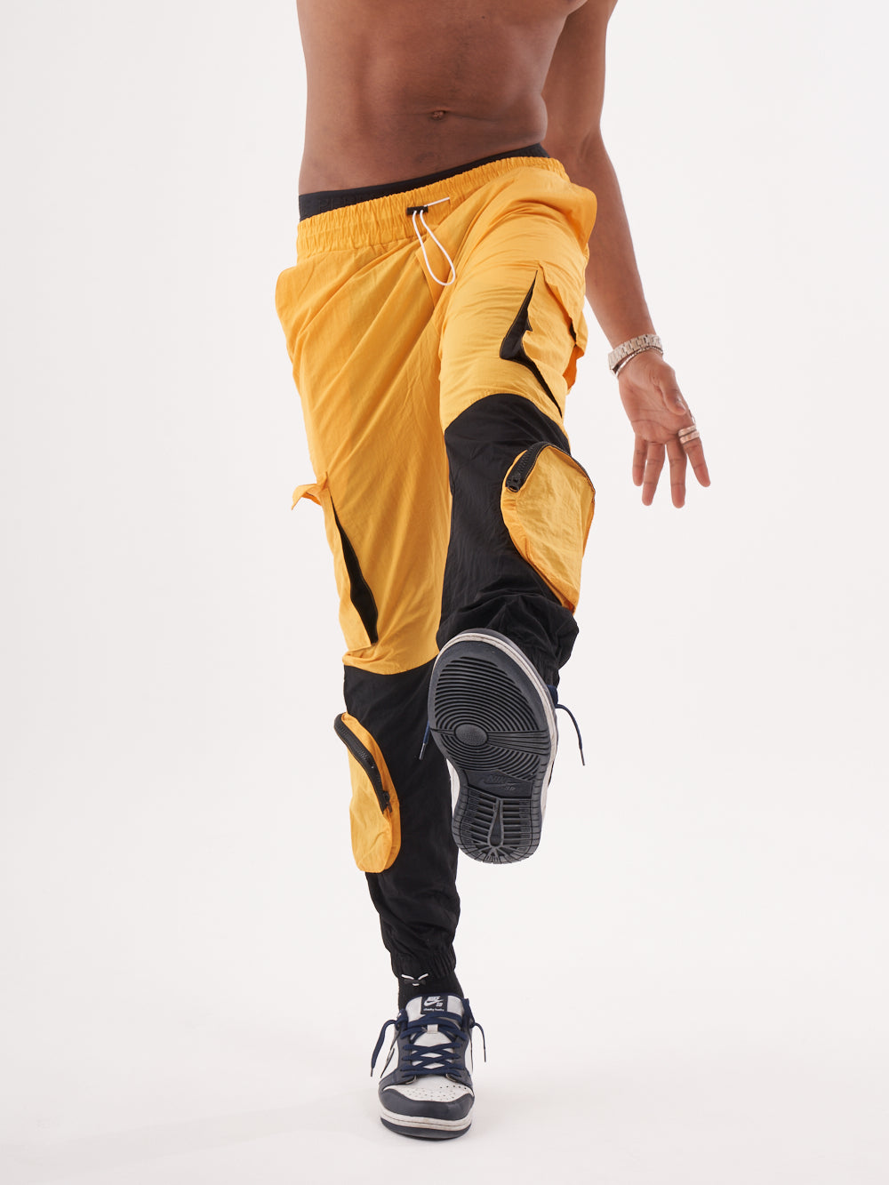 A man is posing in a RENEGADE | YELLOW.