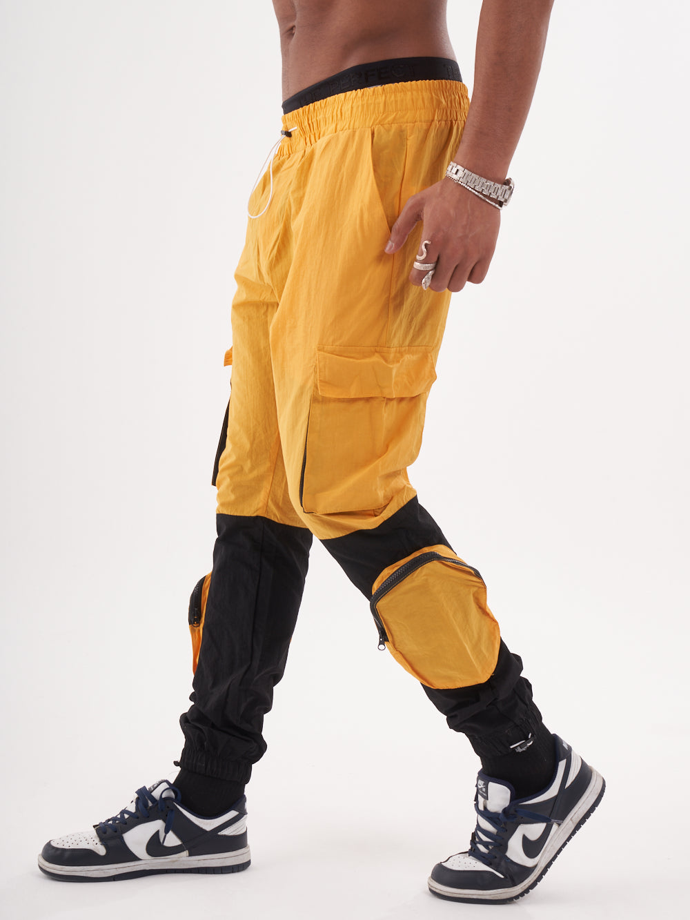 A man wearing RENEGADE | YELLOW cargo pants.