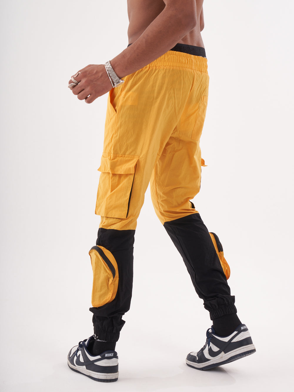 A man wearing RENEGADE | YELLOW cargo pants.