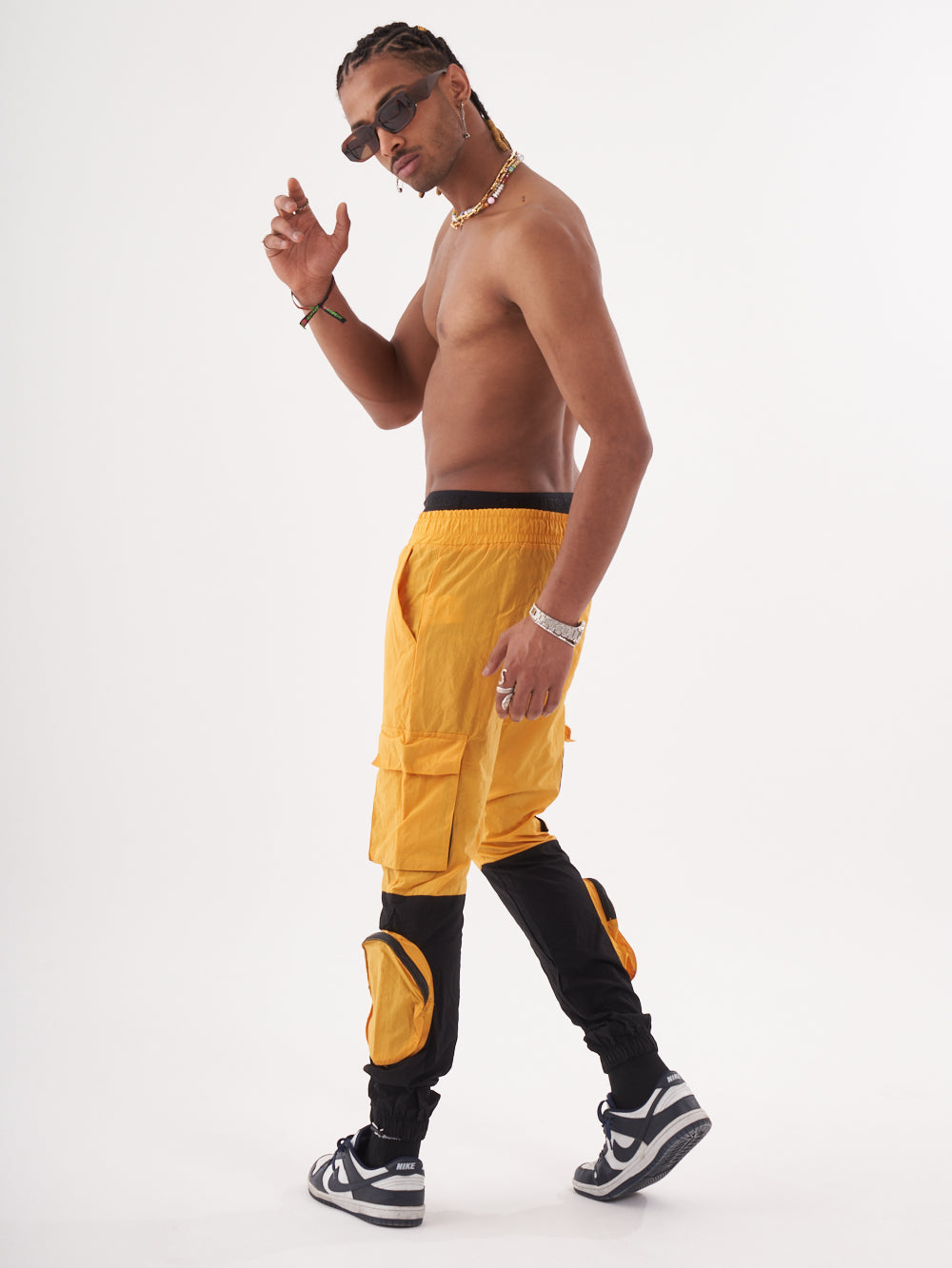 A man in RENEGADE | YELLOW cargo shorts is posing for the camera.