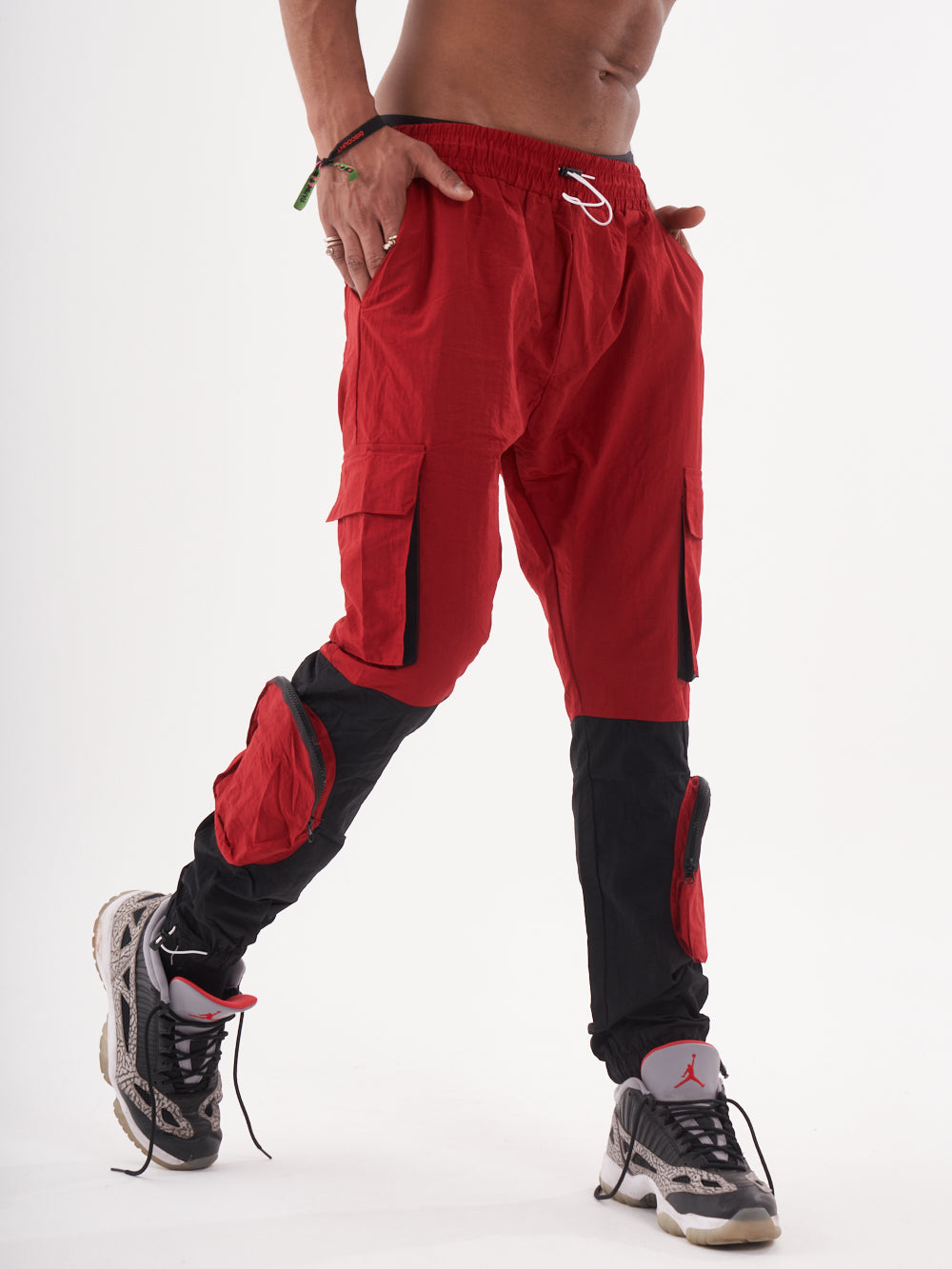 A man wearing RENEGADE | RED cargo pants.