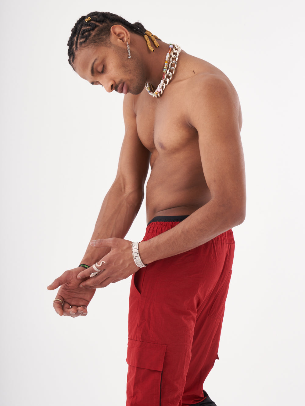 A man in RENEGADE | RED cargo pants is posing for a photo.