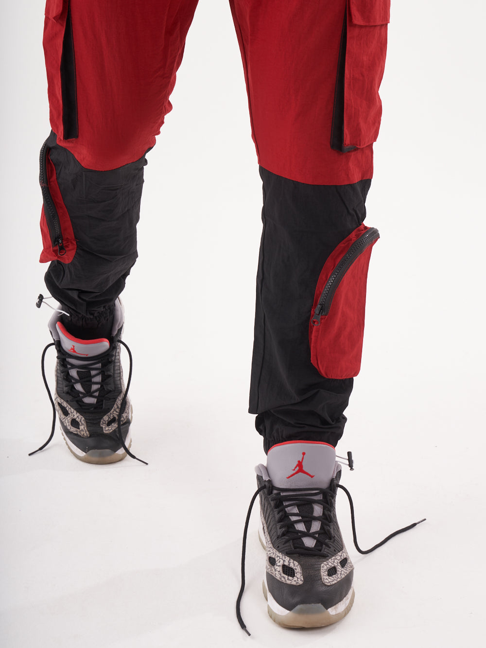 A man wearing RENEGADE | RED cargo pants.