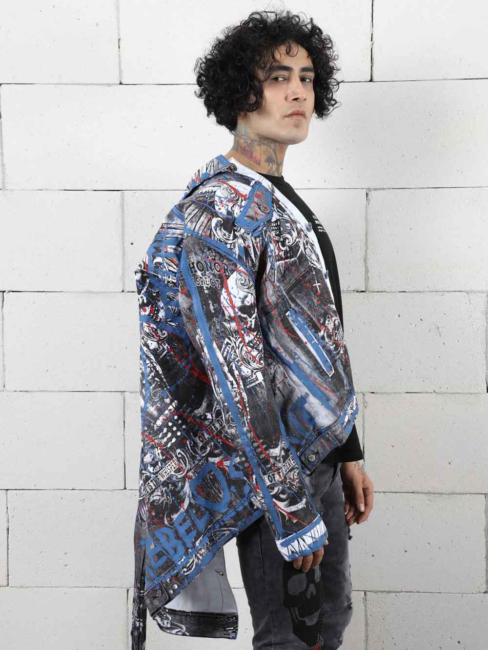 A man wearing a LA VIDA LOCA-covered jacket with skinny fit jeans.