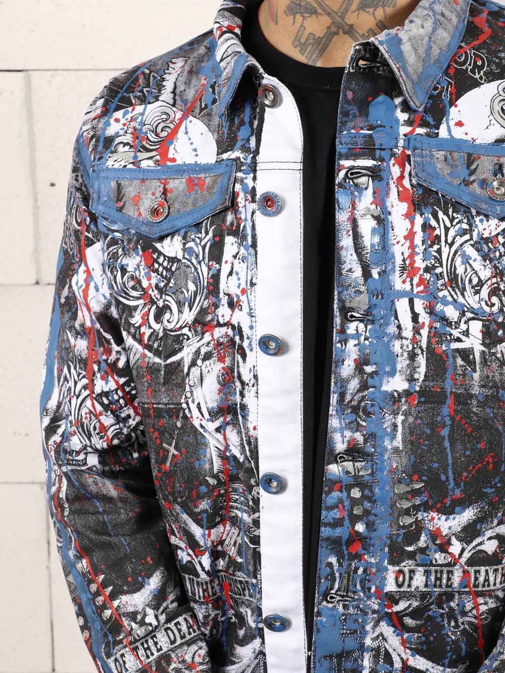 A man in a LA VIDA LOCA-covered denim jacket.